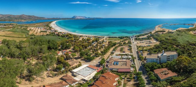 Costa con spiaggia e infrastrutture turistiche.