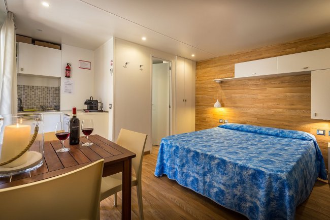 Camera con letto matrimoniale e tavolo apparecchiato.