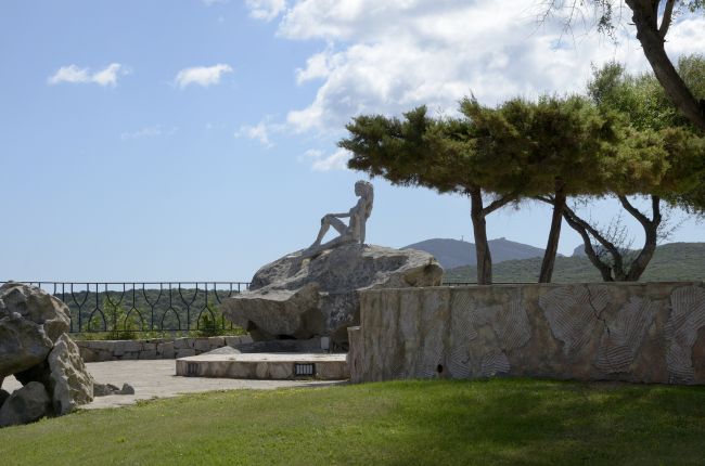 Statua su una roccia accanto ad alberi.