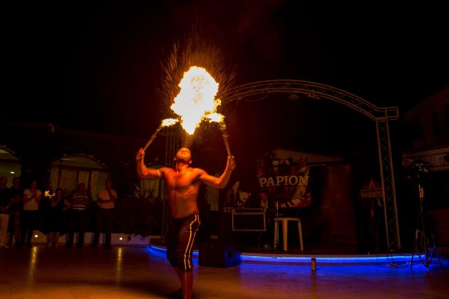 Performer sputa fuoco in uno spettacolo notturno.