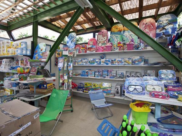 Negozio con scaffali pieni di giocattoli da spiaggia e accessori colorati.