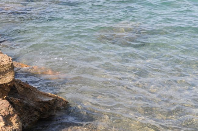 Acqua cristallina vicino a rocce marroni.
