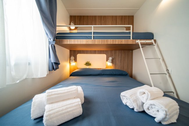 Letto matrimoniale con letto a castello sopra.